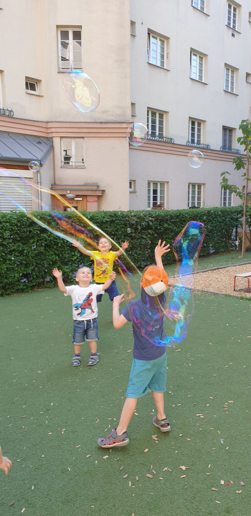 Kinder stellen freudig Riesenseifenblasen her
