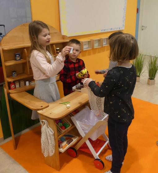 Drei Kinder beim Rollenspiel im Kaufhaus