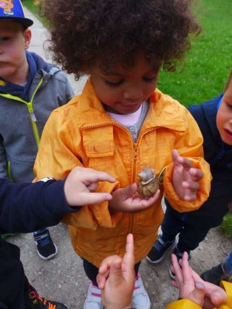 Kind hätl eine Schnecke